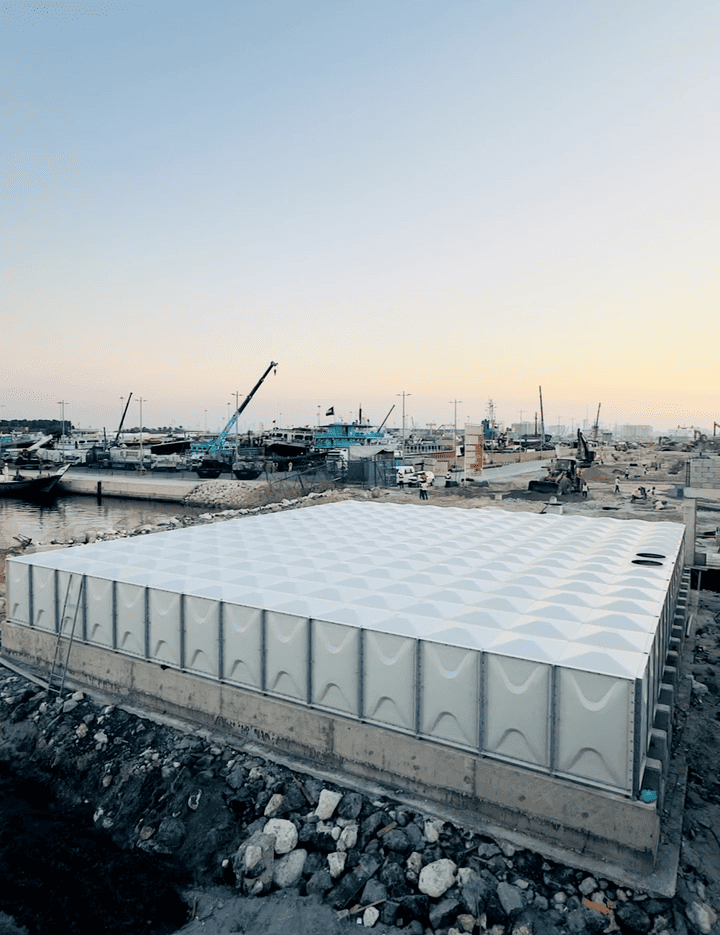 Completed ZISIF GRP tank at dusk near a harbor